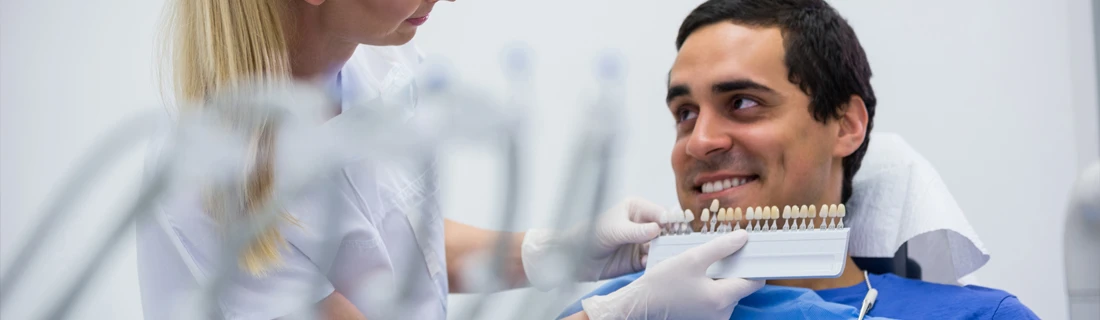 Dental Professional Comparing Tooth Shades