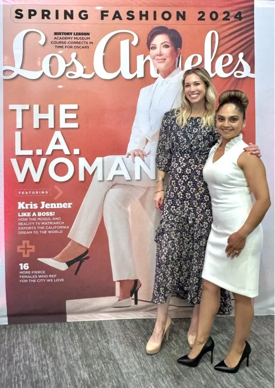 Two People Standing In Front Of A Los Angeles Magazine Display