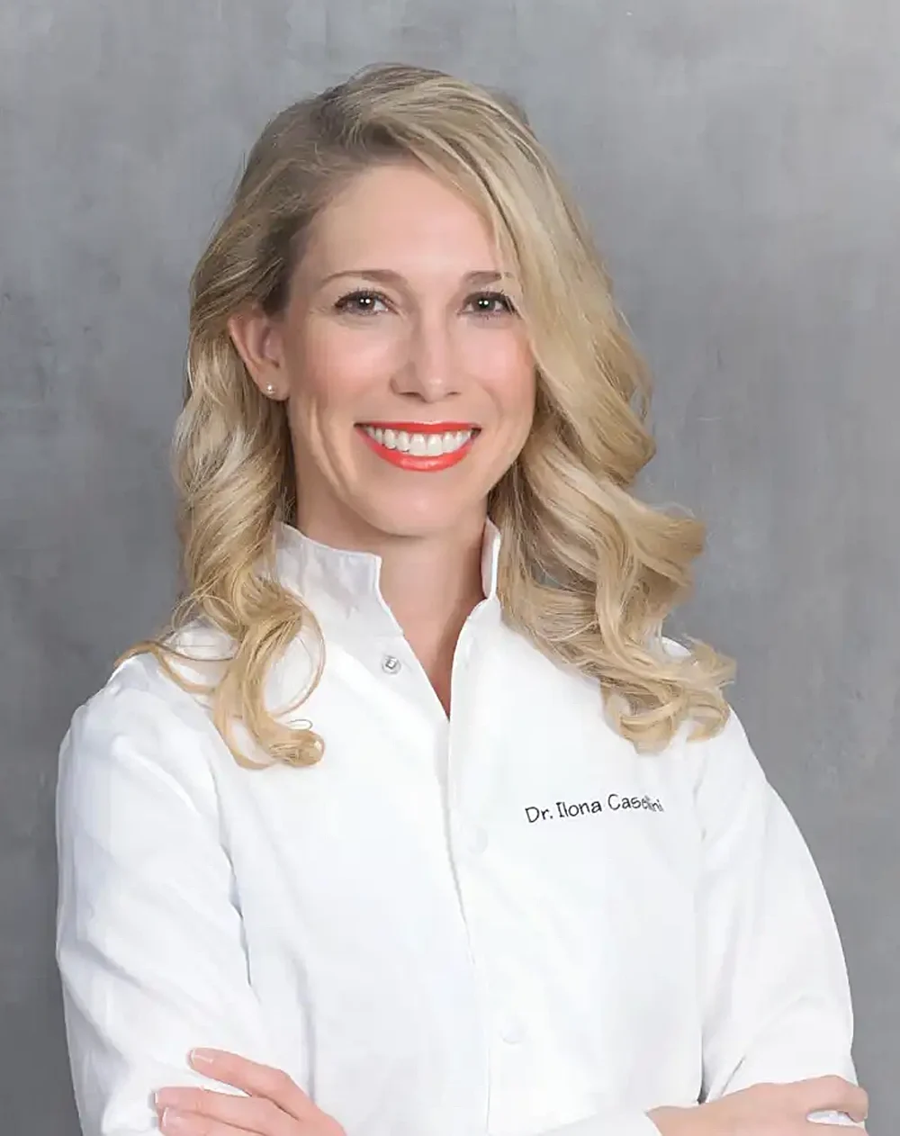 Professional Headshot Of Dentist Wearing White Clinical Coat