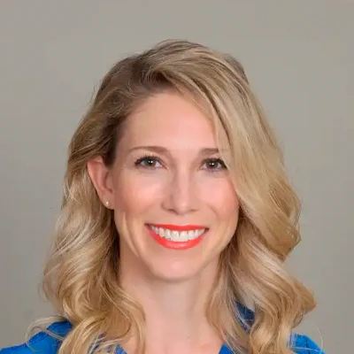 Professional Headshot Of A Person With Shoulder-Length Wavy Blonde Hair